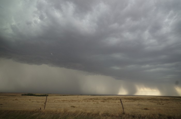 Massive rain shaft and hail core of the merging storm with a stronger outflow.