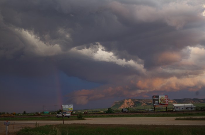 Rotating Wall Cloud with a Rainbow in Front of Scotts Bluff